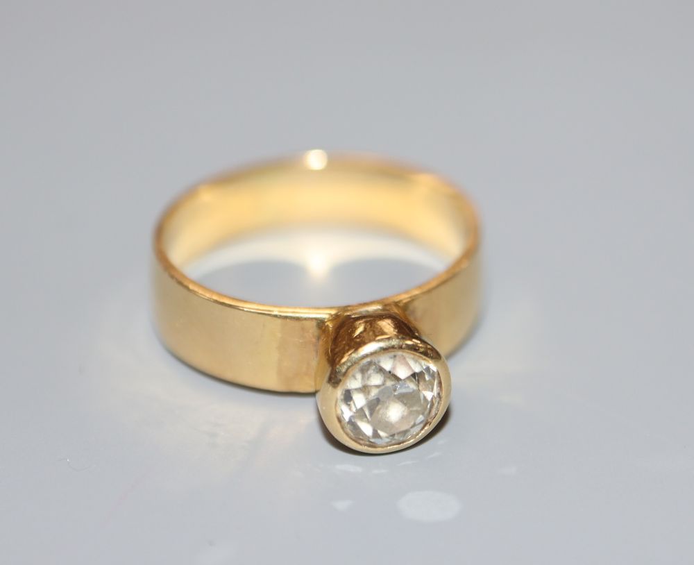 An 18ct gold and collet set solitaire diamond ring, size M, gross 4.6 grams.